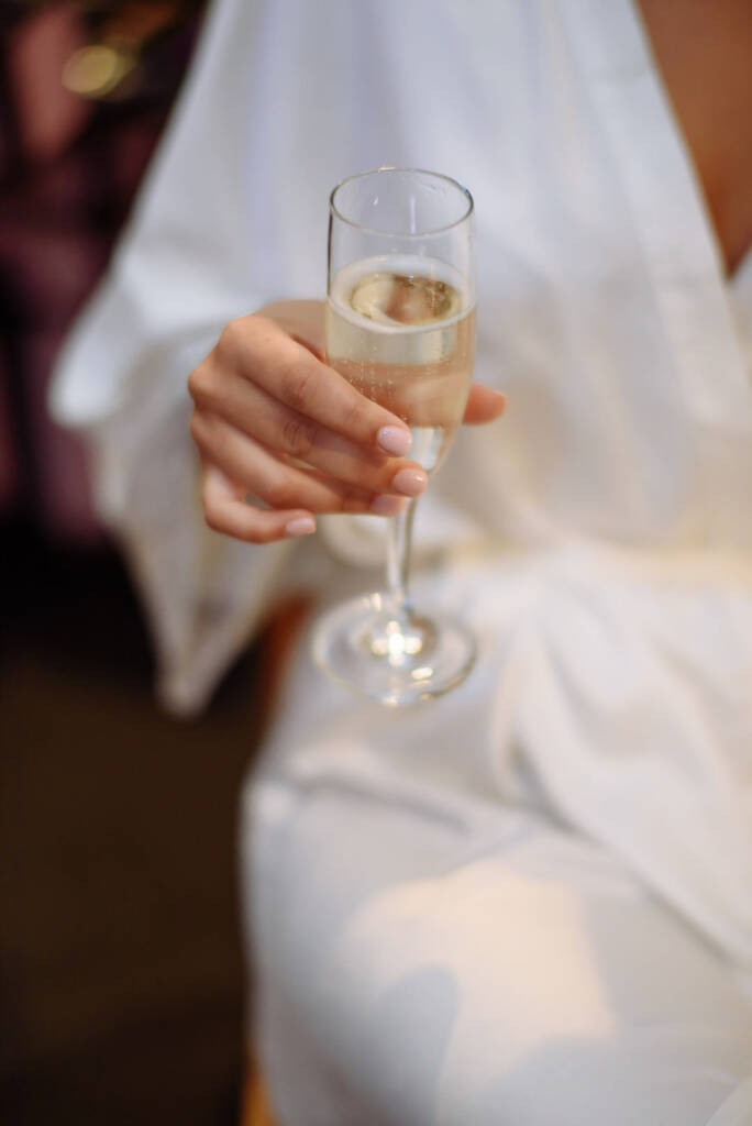 A steady hand cradles the first champagne of the morning