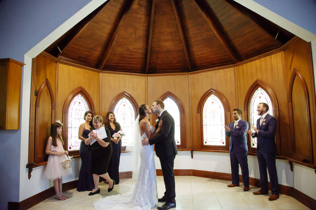 The first kiss inside the eight-sided chapel draws applause