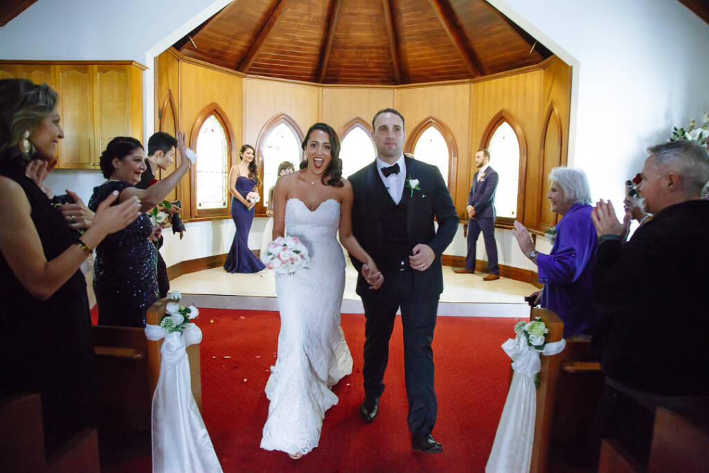 An open-mouthed cheer as they stride back up the red aisle
