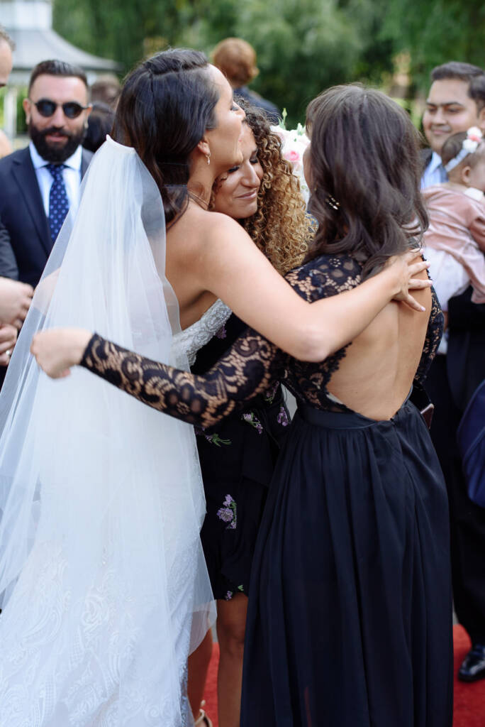 A soft kiss on the cheek amid the crowd of well-wishers