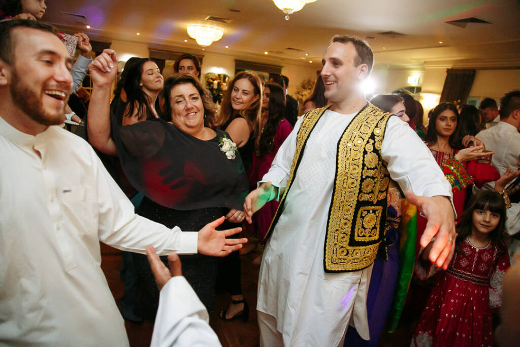 Arms spread wide, the gold vest anchors the whirling circle