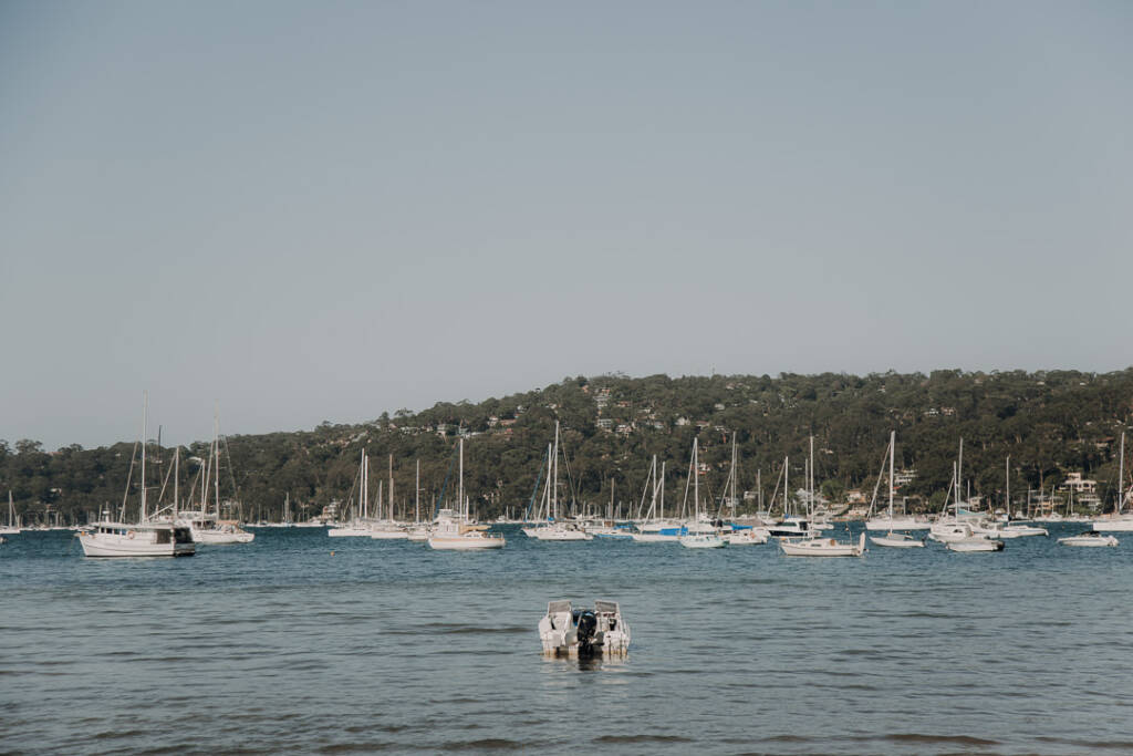 Moored yachts fill Pittwater below wooded hills beside Bayview Yacht Racing Association on the Northern Beaches.