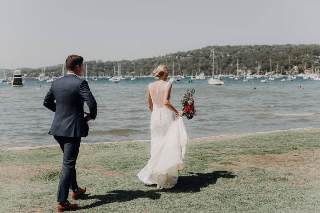 Emma stands ahead of Sean on the waterfront lawn near Bayview Yacht Club.