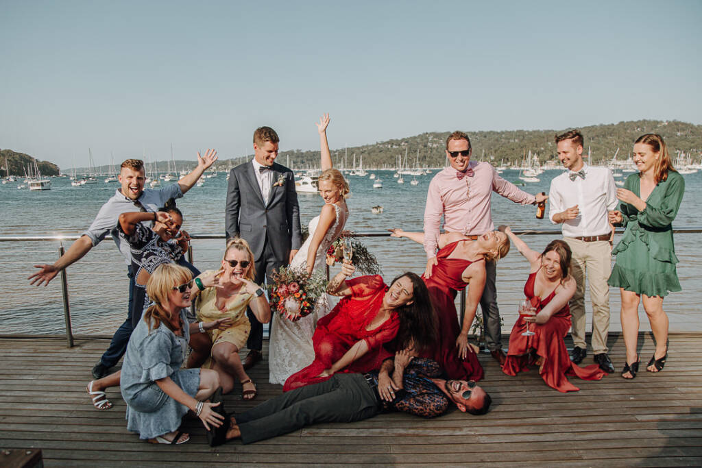 Emma, Sean and their guests strike playful poses beside the railing at Bayview Yacht Racing Association.