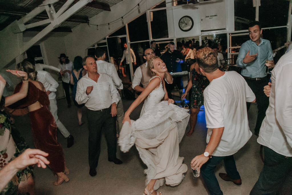 Emma lifts her lace skirt while dancing among guests at Bayview Yacht Racing Association.