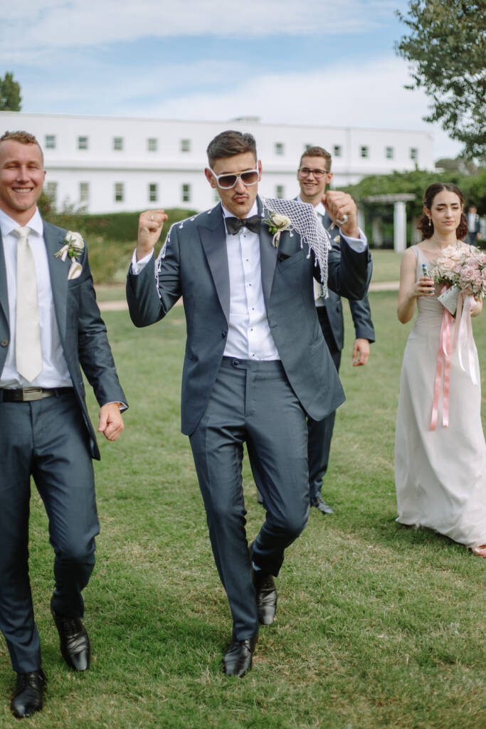 George leads the wedding party across the lawn at Old Parliament House Gardens.