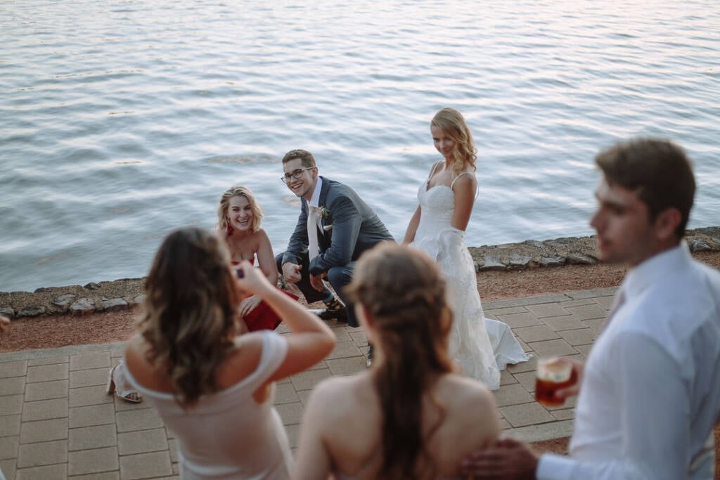 Becky and George mingle beside Lake Burley Griffin during their reception at The Boat House by the Lake.