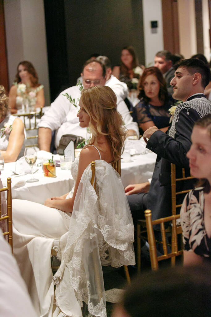 Becky and George sit among guests during the fine-dining reception at The Boat House.