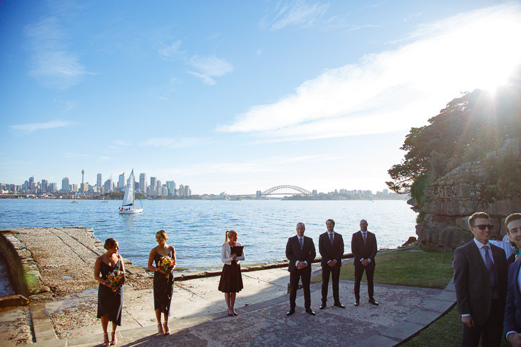The wedding party and celebrant wait beside Sydney Harbour at Bradleys Head