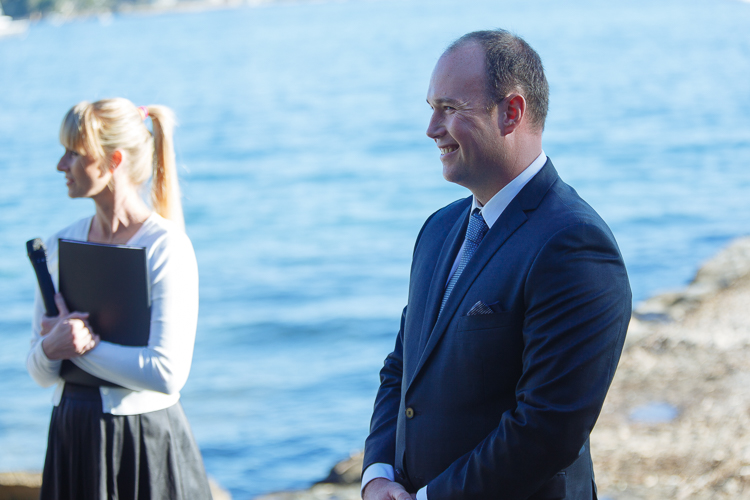 Arthur smiles beside the celebrant before the wedding ceremony at Bradleys Head