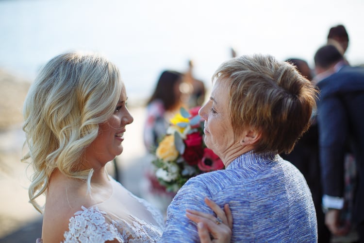 Sabine smiles while holding an older woman's arm after the ceremony