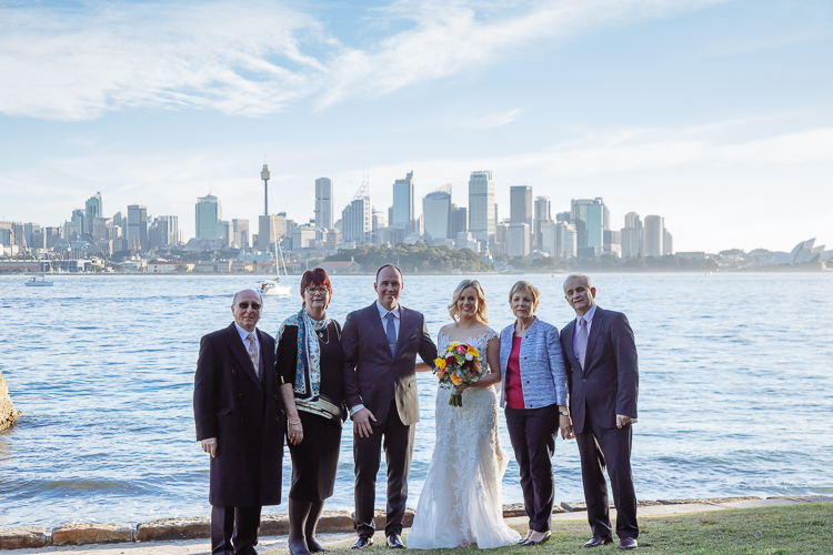 Sabine and Arthur pose with four guests beside the harbour at Bradleys Head