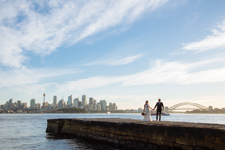 Sabine and Arthur stand on Bradleys Head jetty with the Opera House and Harbour Bridge behind