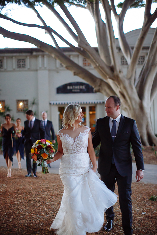 Sabine and Arthur walk beneath spreading branches outside Bathers' Pavilion in Balmoral
