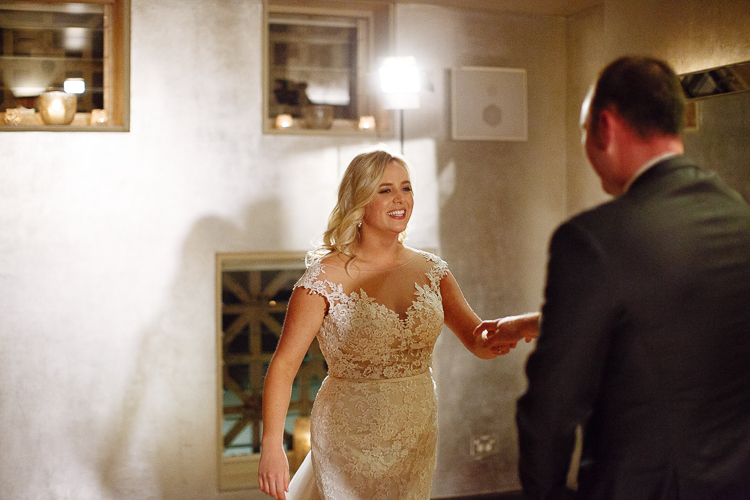 Sabine reaches for Arthur's hand during their first dance at Bathers' Pavilion