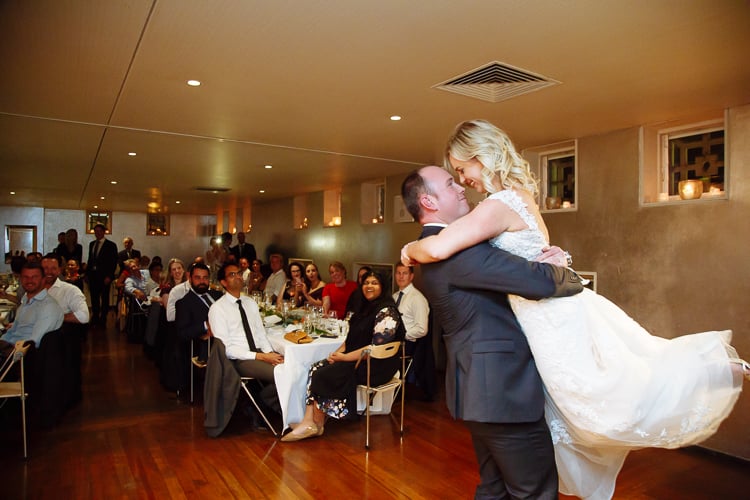 Arthur lifts Sabine during their first dance as guests watch at Bathers' Pavilion