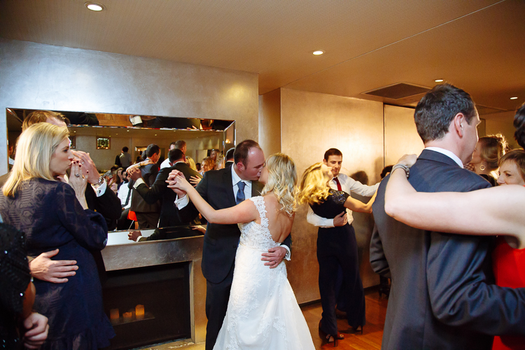 Sabine and Arthur kiss among dancing guests at their Bathers' reception