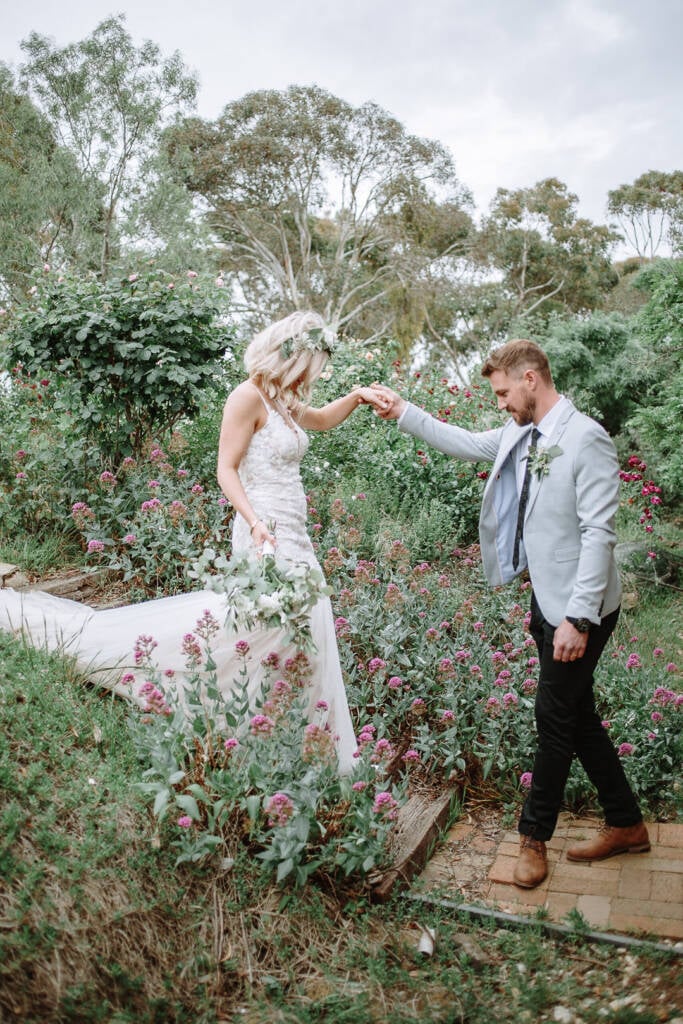 Tory helps Kelly step through the flower garden at Sunnystones.