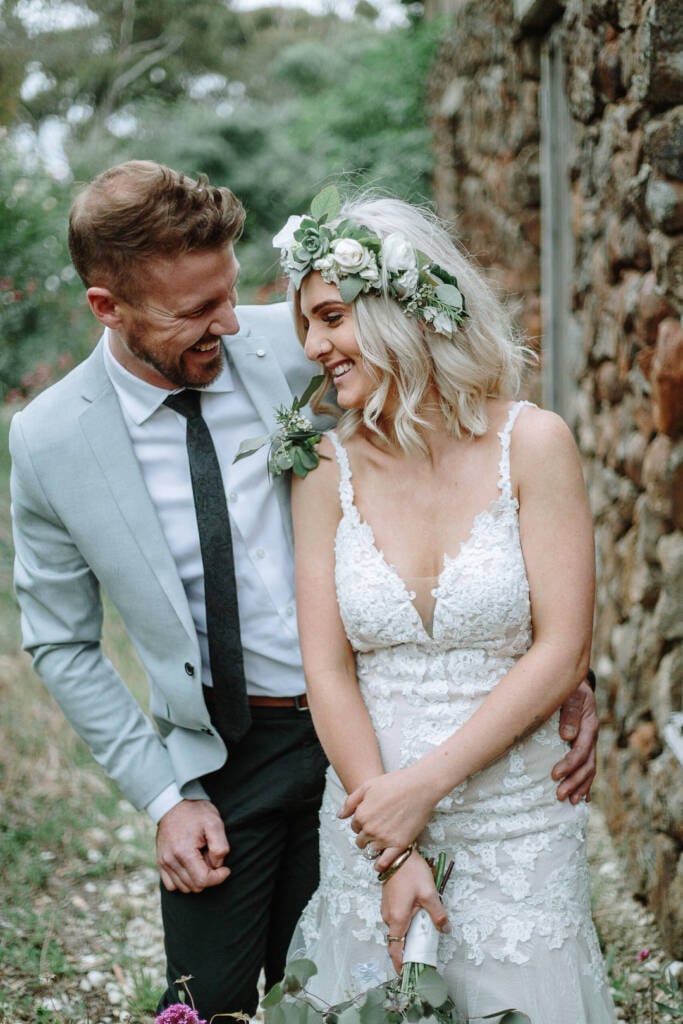Kelly and Tory laugh beside the old stone wall at Camp Sunnystones.
