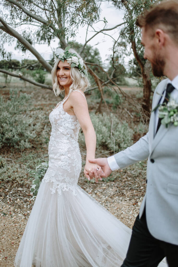 Kelly smiles while holding Tory’s hand during a portrait at Sunnystones.