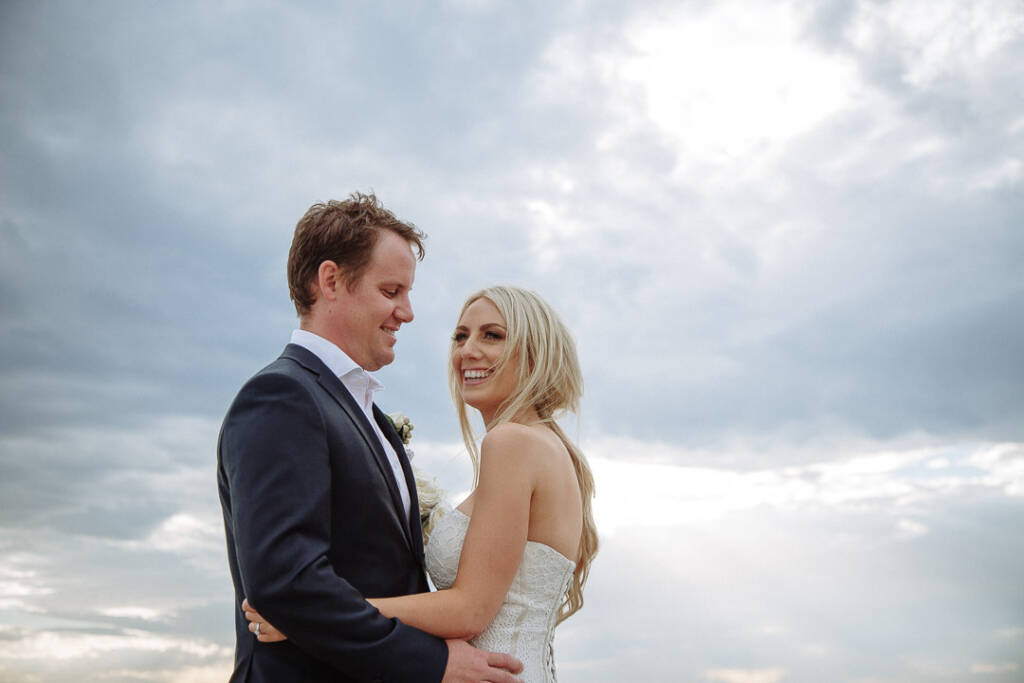 Nick smiles down at Aasher as she laughs in his arms.