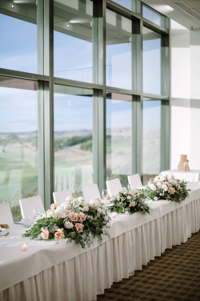 The bridal table at The National Golf Club faces the links and coastline through floor-to-ceiling windows.