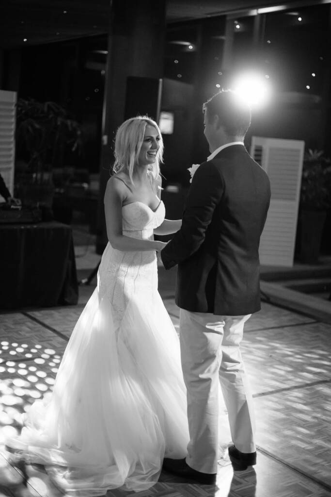 Aasher laughs during the first dance at The National, a bright light behind Nick.