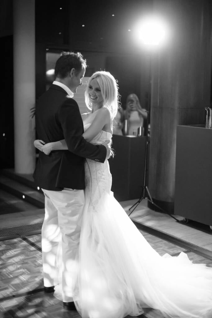 Aasher rests near Nick as they dance at The National Golf Club, her train spread wide.