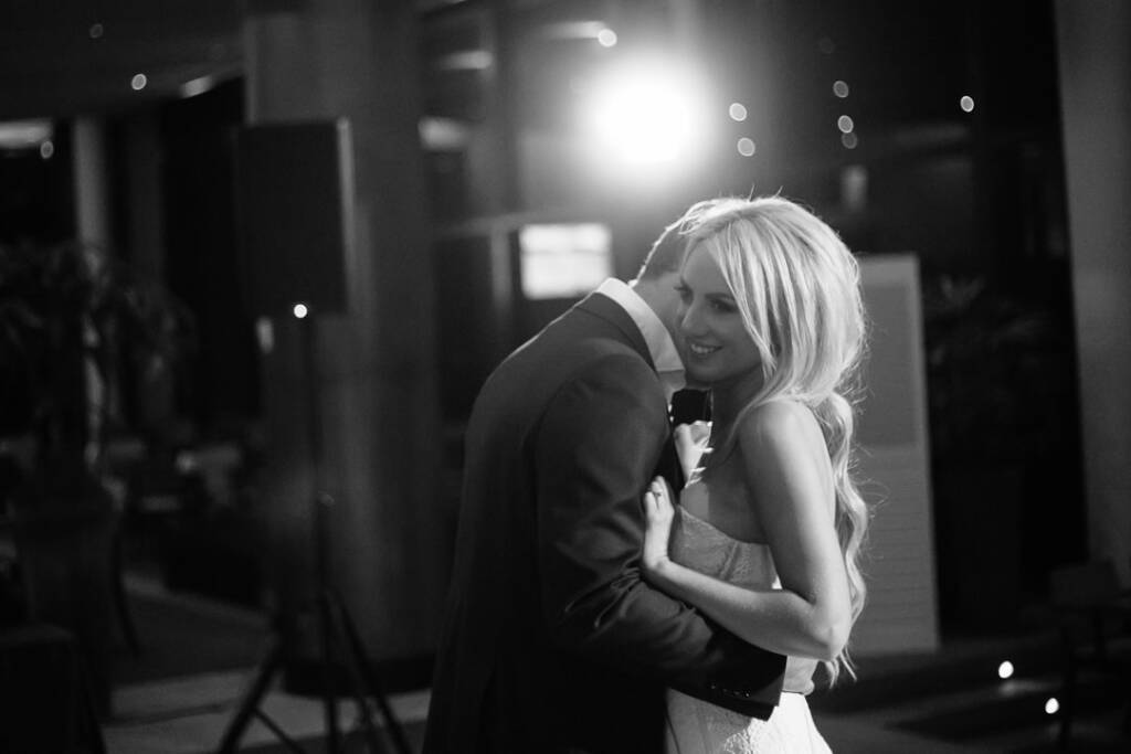 Aasher rests her head on Nick's chest during a backlit slow dance at The National.