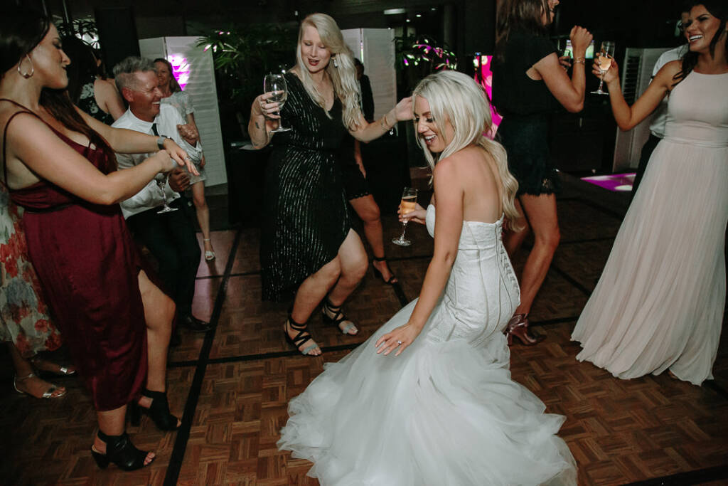 Aasher dances with a flute in hand on The National's parquet dance floor.