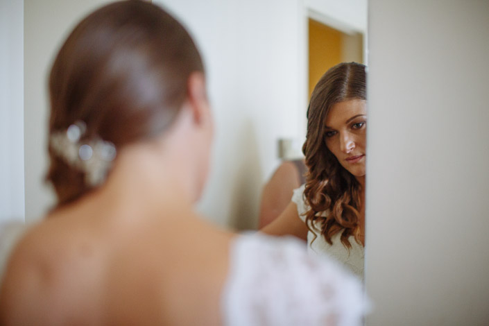 Serious eyes in the mirror above the lace cap sleeve