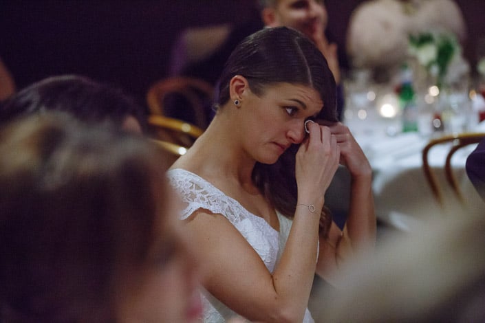 The bride dabs her eye during the reception at Boulevard in Kew.