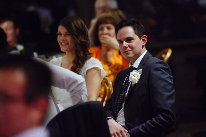 Pasquale sits beside a smiling Pascale during their wedding reception.