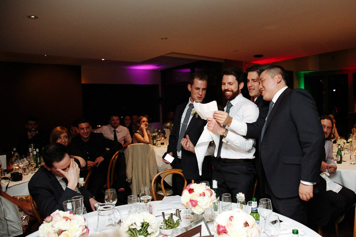 Four men stand with speech notes as Pasquale covers his face at Boulevard in Kew.
