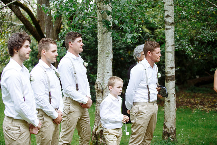 Mitch and three groomsmen in braces stand beneath silver birches with a page boy in front.