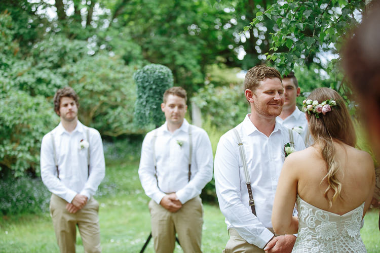 Seen from behind with roses in her hair, Elysha is smiled at by Mitch.