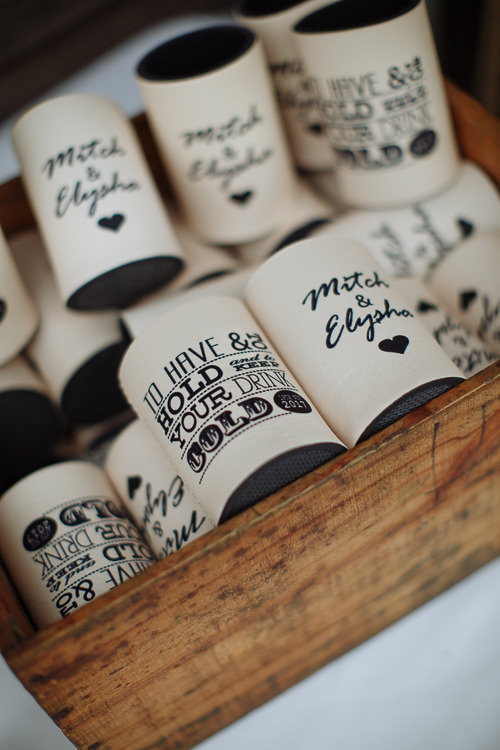 A timber crate of stubby holders printed Mitch and Elysha, to have and to hold.