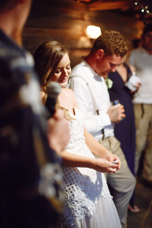 Smiling with eyes closed as a microphone is held toward her, Elysha stands beside Mitch.