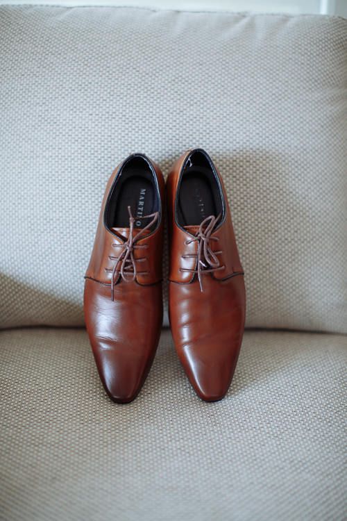 Groom's tan leather wedding shoes styled on linen – morning details