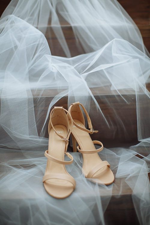 Bride's strappy nude heels wrapped in the veil – bridal details