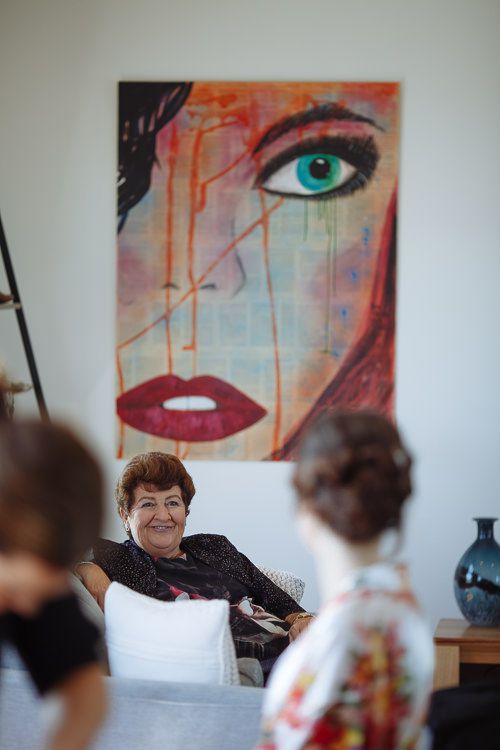 Grandmother watching the bridal preparations with a smile
