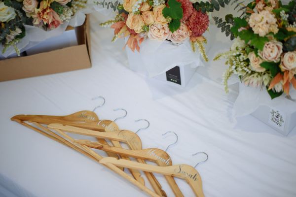 Personalised timber hangers and florals ready for the bridal party