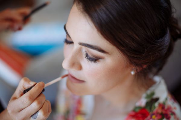 Bride's lipstick being applied – final makeup touches