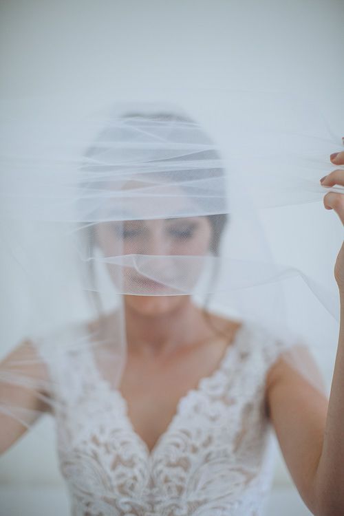 Bride beneath her veil – soft bridal portrait