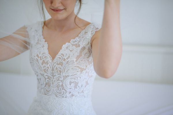 Detail of the lace bodice as the bride lowers her veil