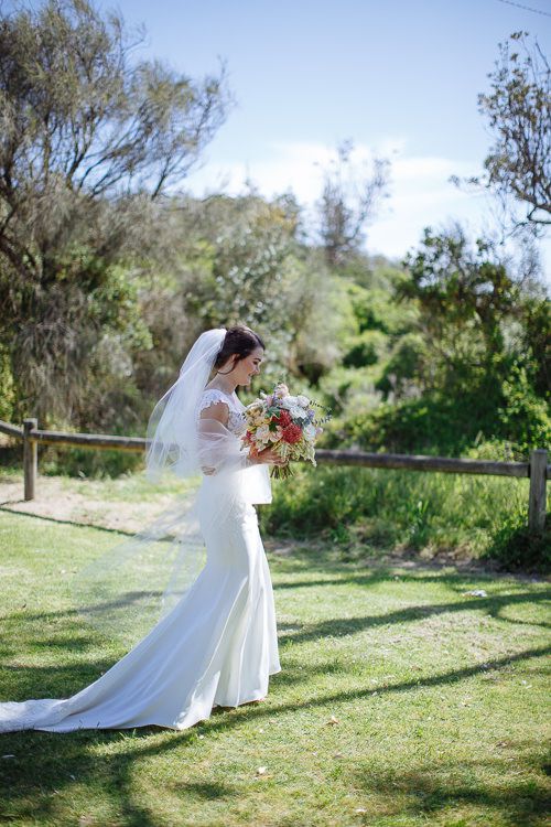 Bride stepping up behind the groom before the first-look reveal