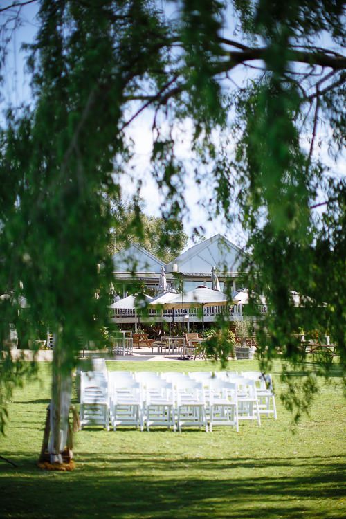 The venue pavilion glimpsed through the willows at Crittenden Estate