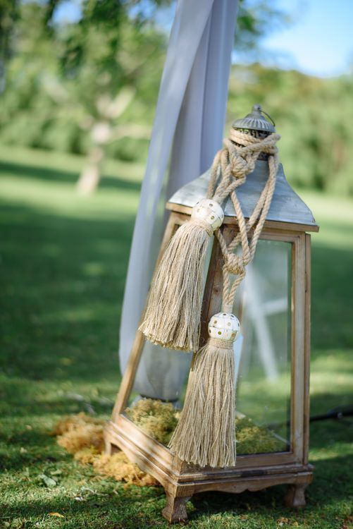 Lantern and rope styling detail at the lakeside ceremony