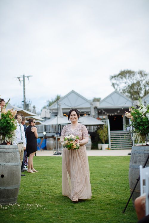 Maid of honour walking the aisle at Stillwater at Crittenden