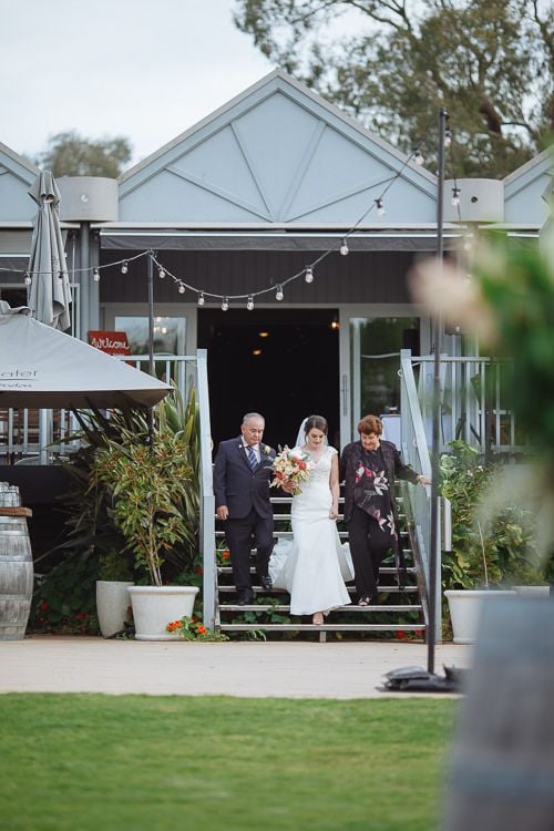 Bride and her father walking down the garden aisle